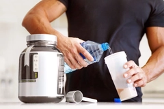 a bodybuilder making himself a protein shake