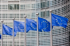 European Commission building and flags.