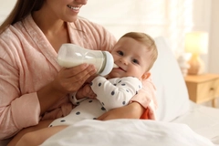 Mother feeding baby formula