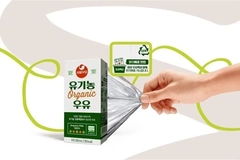 A hand pulling a layer of package out of a box