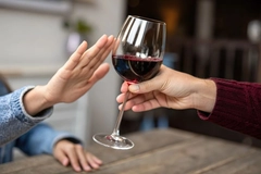 person refuses wine glass offer