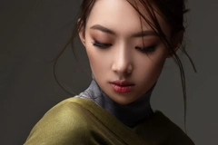 korean woman in green top looking downwards