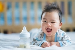 Happy Asian baby drinking milk Happy Asian baby drinking milk