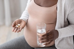 Pregnant woman taking supplements
