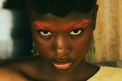 woman with red eyebrows looking directly into camera