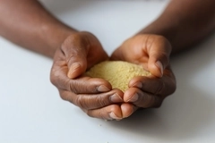 Sudanese woman holding grains of rice Sudanese woman holding grains of rice