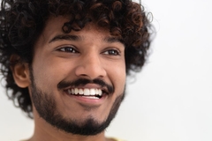 A man smiling with white teeth.