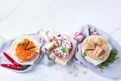 three types of vegan cheese on wooden boards