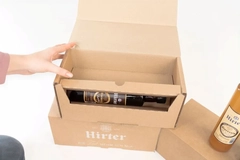 cardboard box with glass bottle inside