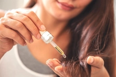 Putting oil on hair.