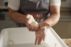 baker's hand shaping dough baker's hand shaping dough