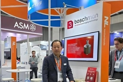 A person standing in front of a booth A person standing in front of a booth