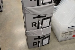 Image A stack of boxes with tags