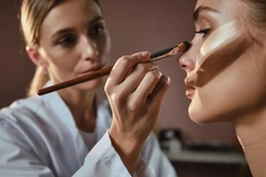 Image woman doing another woman's makeup