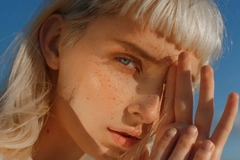 A woman with the sun in her face.