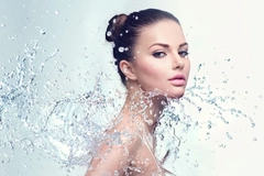 A woman posing with water thrown over her.