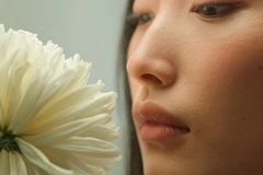 Image close up of a woman and a flower