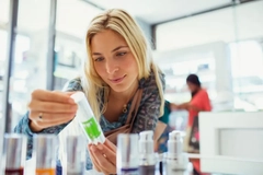 A girl inspecting a personal care product.