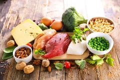 protein sources of food on wooden background cheese, meat, beans and seeds on wooden background