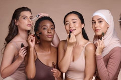 Four women with makeup products