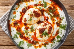 bowl of soup on wooden table bowl of white soup with dough balls on wooden background