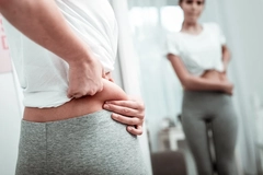 Woman examining her body fat Woman examining her body fat
