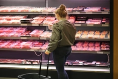Image Woman shopping for hybrid meat.