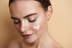 peaceful young lady with makeup and heart picture on face