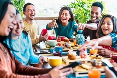 Happy people eating around a table. Happy people eating around a table.