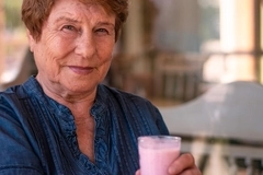 Image Elderly woman drinking protein shake