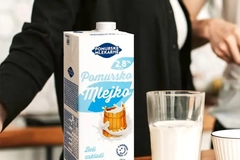 Image A carton of milk and a glass of milk
