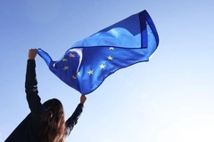 Image A girl holding an EU flag.