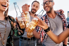 Image Young consumers drinking alcohol-free beer at party.