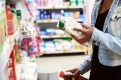 Image A person choosing beverage products in a shop