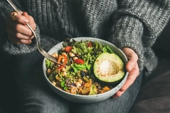 Image woman eating salad from a bowl