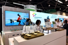 two women in white shirts at a trade show