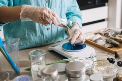 Hands making a natural beauty product.