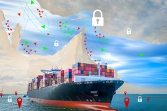 Cargo ship on ocean with map of Strait of Hormuz overlay