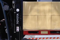 Image A forklift with a stack of boxes wrapped in a film