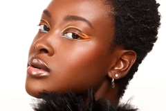 A woman with colorful funky graphic eyeliner.