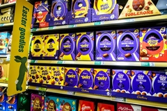 Cadbury Creme Eggs and other Easter goodies on a grocery store shelf.
