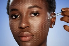 Image Woman applying cosmetics to her face with holographic skin tech