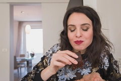 Image woman eating chocolate brownie at home