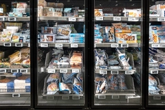 Fish and food frozen in packs displayed in Aldi supermarket display cabinets.