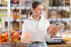 Image Young consumer shopping for seafood.