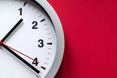 Image white and black clock on red wall