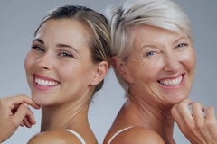 Young and old woman smiling at camera