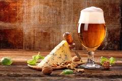 Cheese and beer on a wooden table. Cheese and beer on a wooden table.