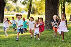 A group of happy children of boys and girls run in the Park