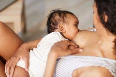 Close-up of young black mother breastfeeding baby